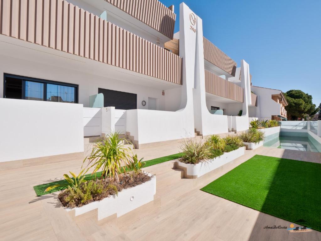 an exterior view of a house with a lawn at FLAMINGOS & SPA JACUZZi in San Pedro del Pinatar