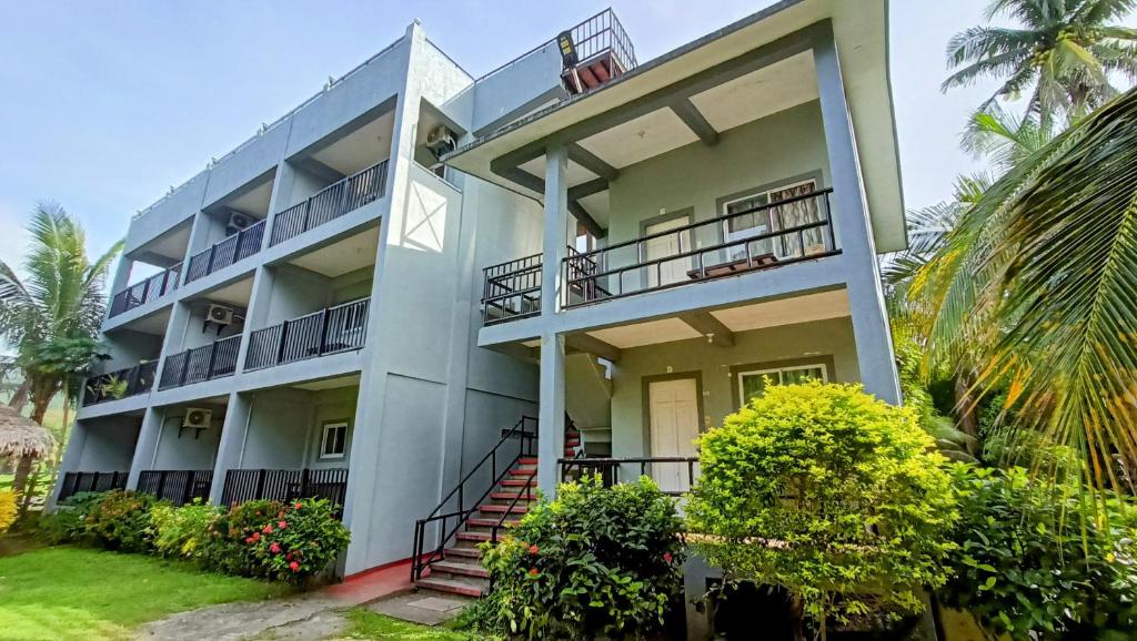 ein Apartmenthaus mit einer Treppe, die hinauf führt in der Unterkunft Suki Beach Resort "3-3" Family Aircon Room in Sorsogon