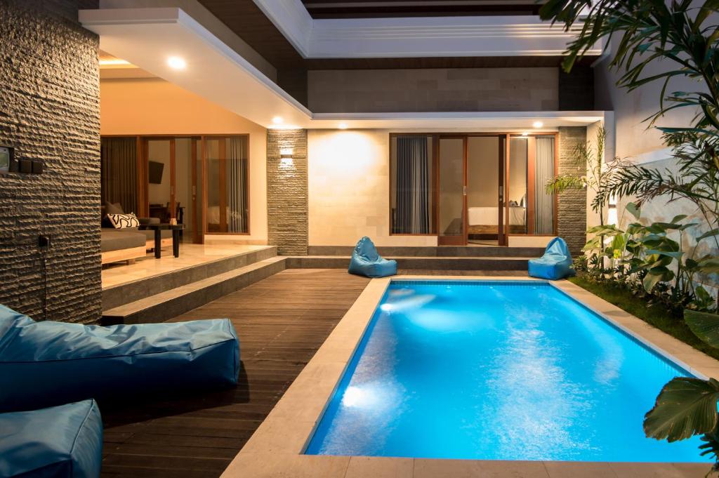 a swimming pool in the middle of a house at Villa Sakura ll seminyak in Seminyak