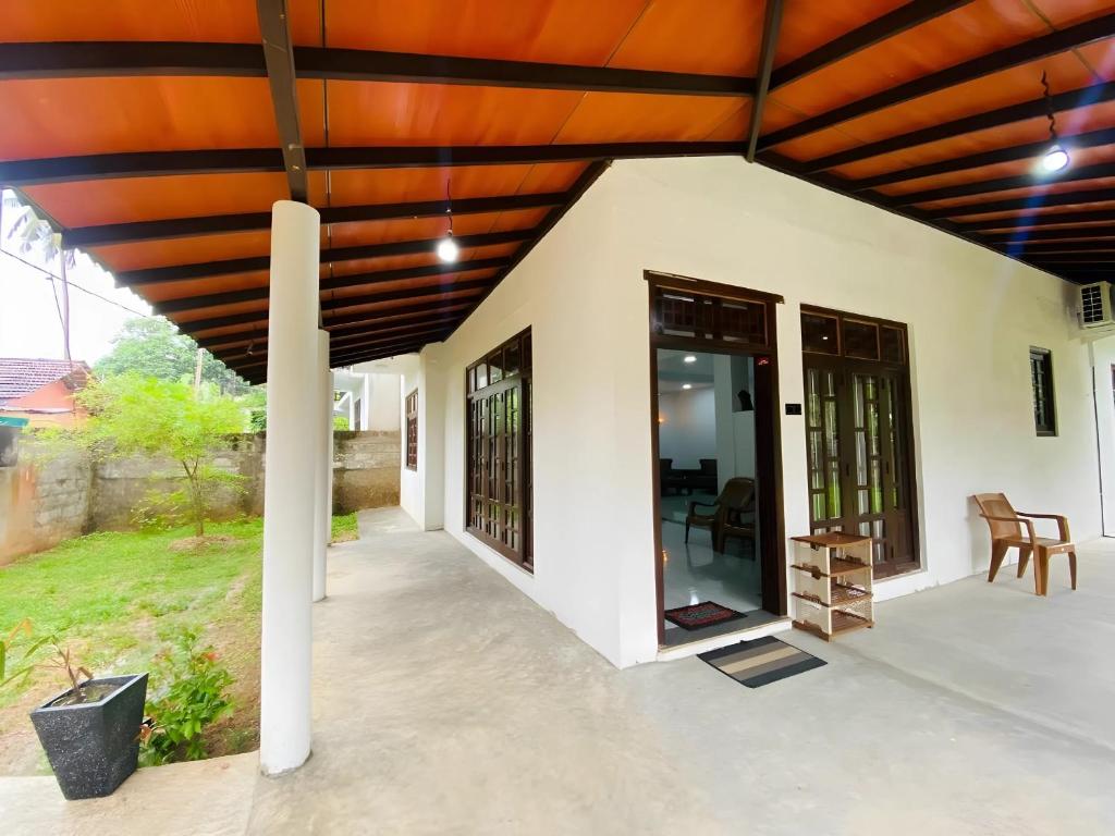a patio with a wooden pergola at Akee villa in Matara