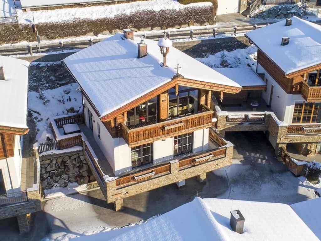 an aerial view of a house in the snow at Chalet with Sauna and Natural Pool in Neukirchen am Großvenediger