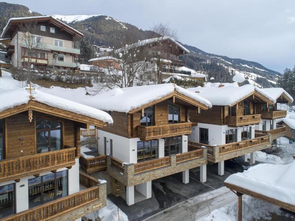 a group of buildings with snow on the roofs at Family Chalet Escape in the Alps in Neukirchen am Großvenediger