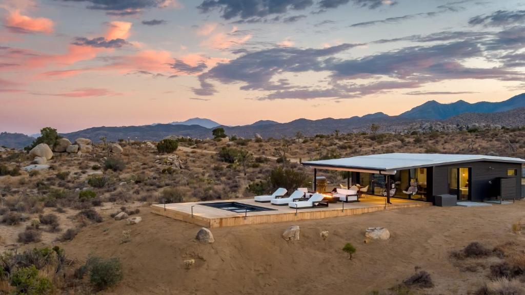 a house in the desert with mountains in the background at Atomic Ranch by Fieldtrip Secluded Pool Views in Pioneertown