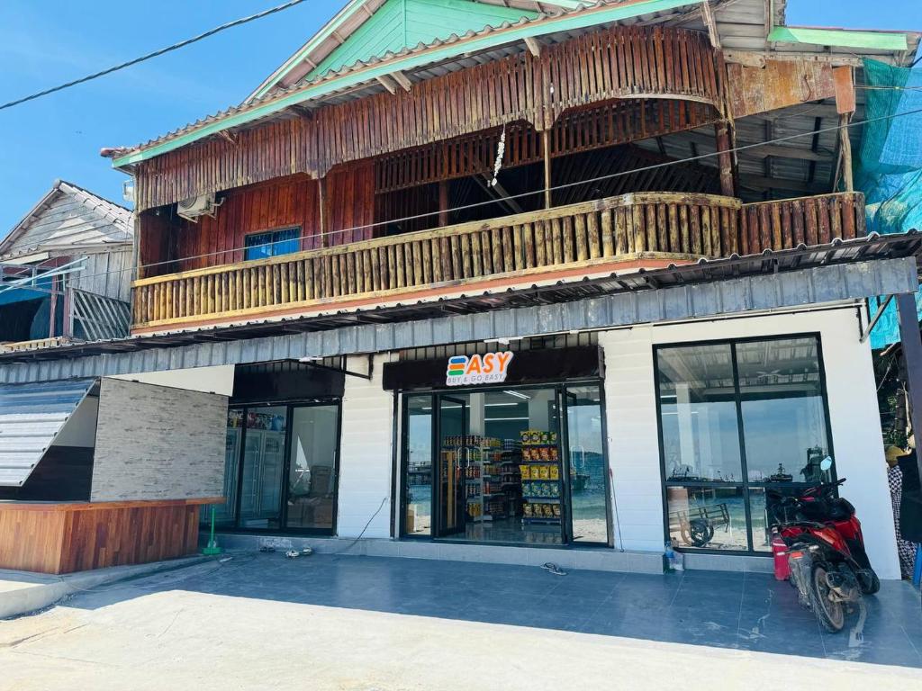 a store with a motorcycle parked in front of it at Easy Home Koh Rong in Koh Rong