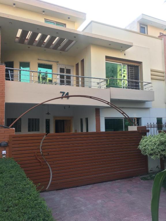 a house with a wooden fence in front of it at SJ Rezidor Guest House in Islamabad