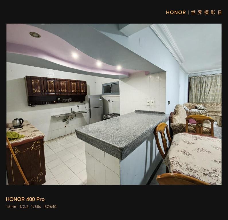 a kitchen with a counter and a table in a room at شقة بكمباود النورس علي البحر بالاسماعيلية in Ismailia