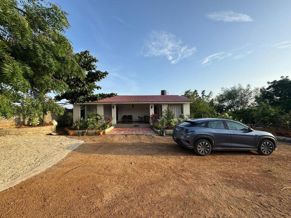 a car parked in front of a house at FF Family Farm in Hyderabad