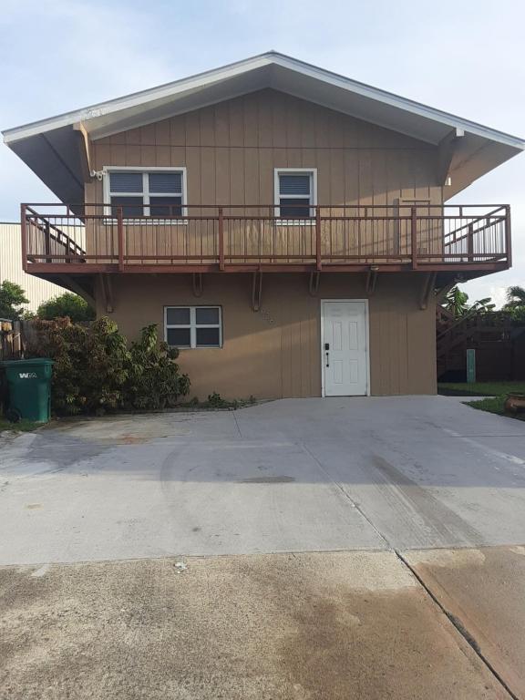 a house with a balcony on top of it at Waterfront Cottage in Marco Island