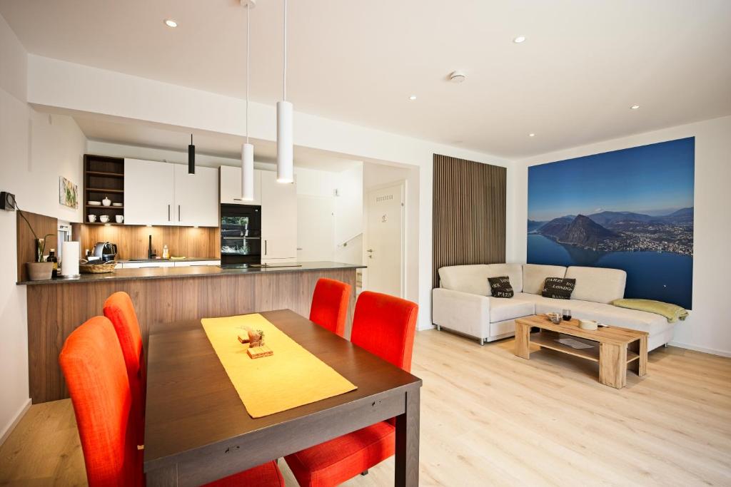 a kitchen and living room with a table and chairs at VARIO-HAUS Residence in Theresienfeld