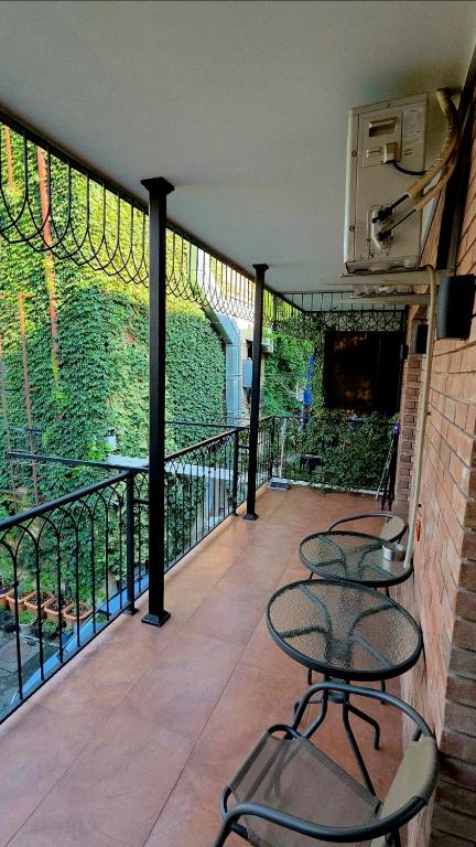 a balcony with two tables and chairs on a building at Nova city center apartments in Tbilisi City