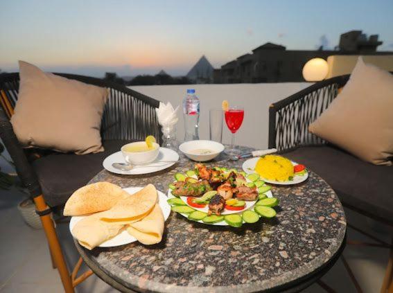 a table with a plate of food on it at Palma Pyramids hotel in Cairo