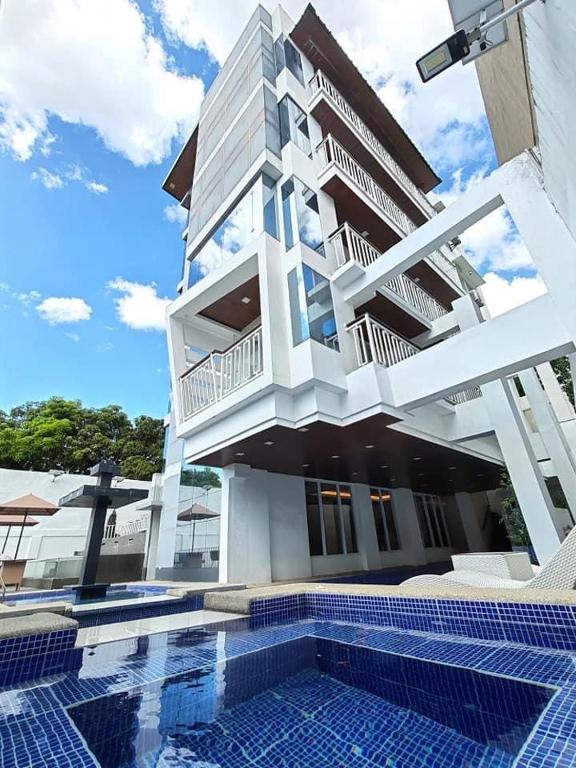 a building with a swimming pool in front of it at 7BR Luxury Resort with Pool and Bar in Sampong