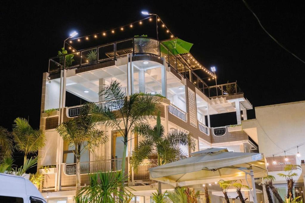a building with a balcony with an umbrella at The rooftop villa 3 in Tây Ninh
