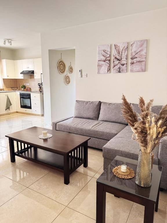 a living room with a couch and two tables at Stay in Harmony in Paralimni