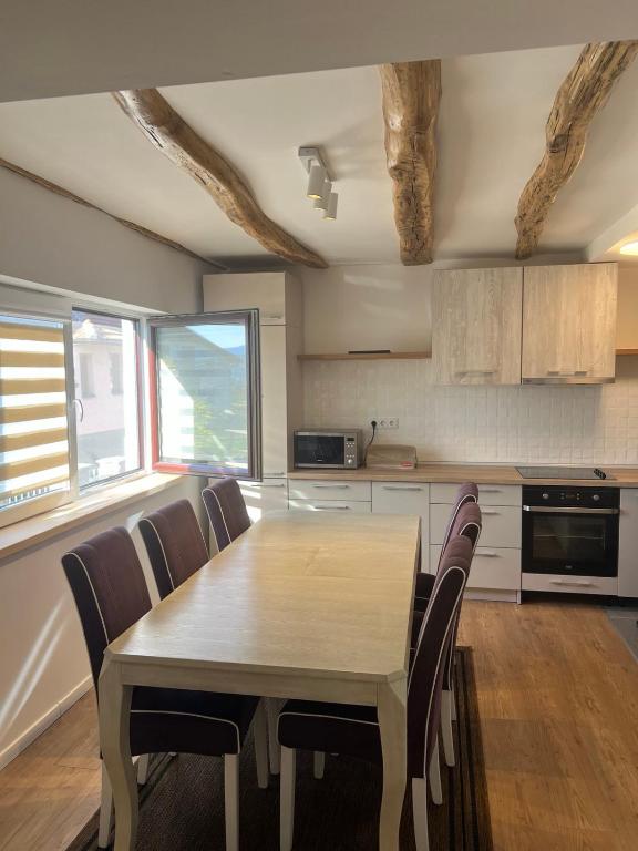 a kitchen with a wooden table and chairs at Travnik Nature in Travnik