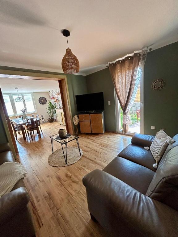 a living room with a couch and a table at le gîte des frangines in Bitche