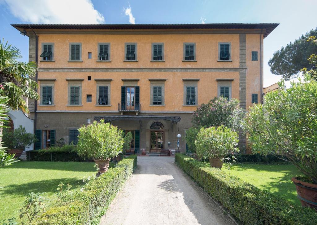an external view of a large building with trees at Casa Santo Nome di Gesu in Florence