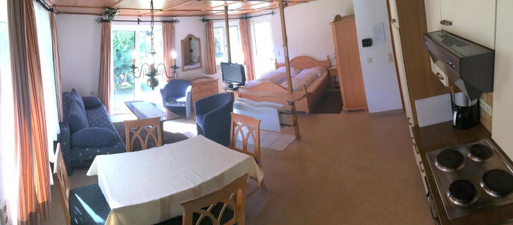 a room with a kitchen and a living room with a table at Ferienappartement in Gortipohl