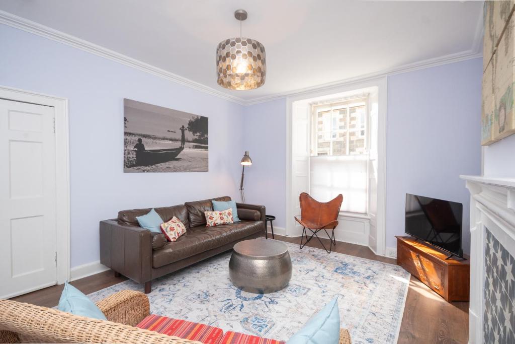 a living room with a couch and a table at Banrigh House in Stirling