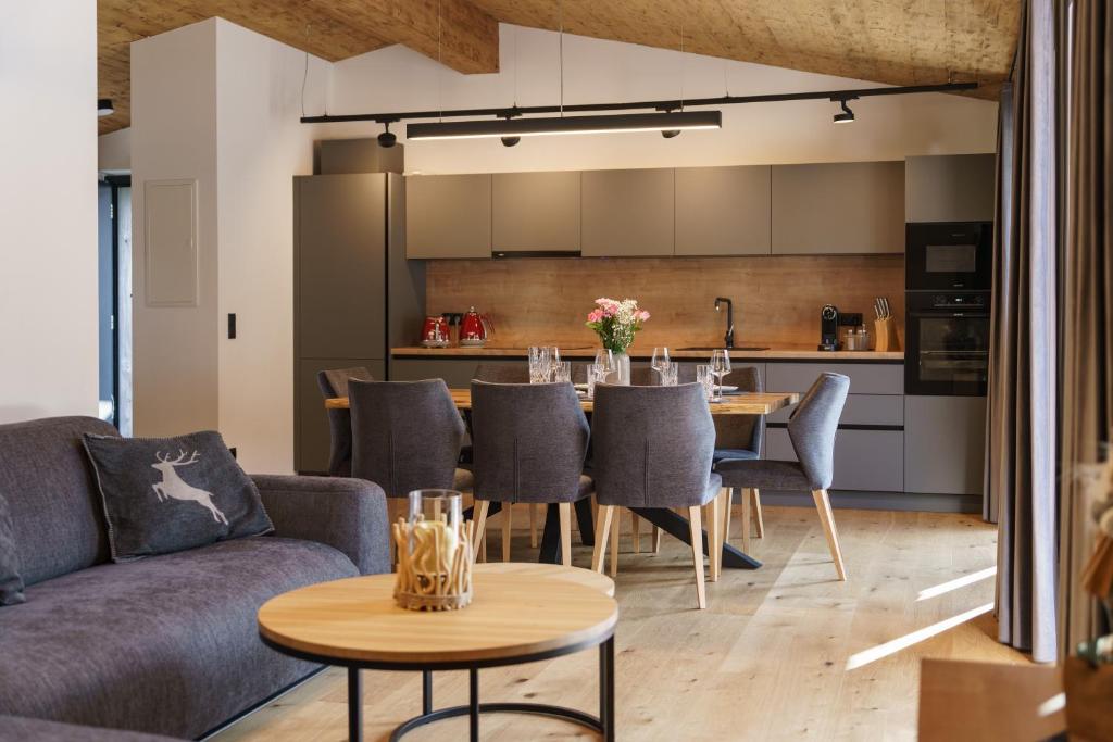 a living room with a couch and a table at Alpenlodge Haus - Summer resort with Schladming-Dachstein Card in Haus im Ennstal