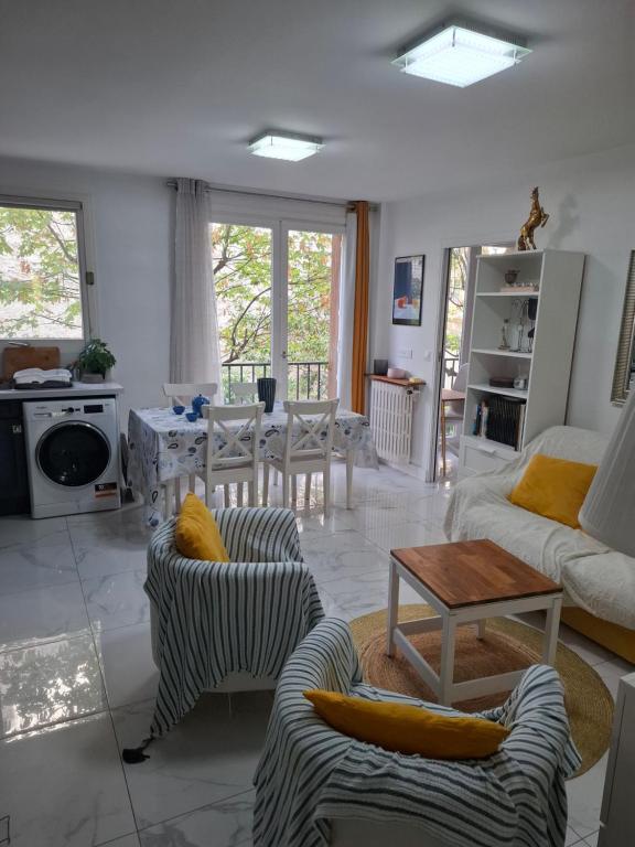 a living room with couches and a table at Very nice private Appartment 1 living room with sofa bed 1 bedroom 1 bathroom with toilet 1 Kitchen in Paris