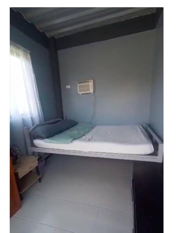 a bunk bed in a room with a window at E&Z guest house in Sara