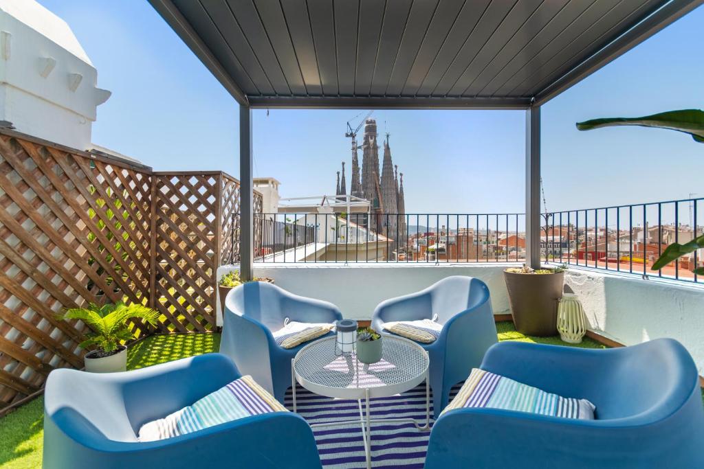 a patio with a table and chairs on a balcony at Suite Home Sagrada Familia in Barcelona