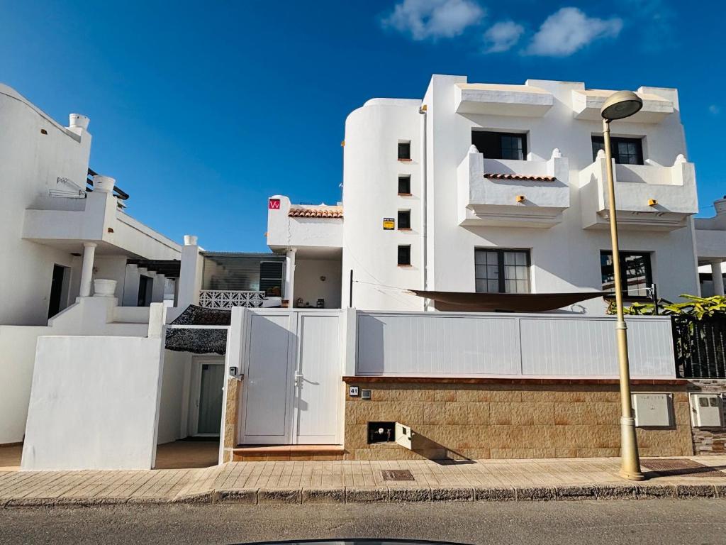 a white building on the side of a street at Atlantic Breeze House in Corralejo