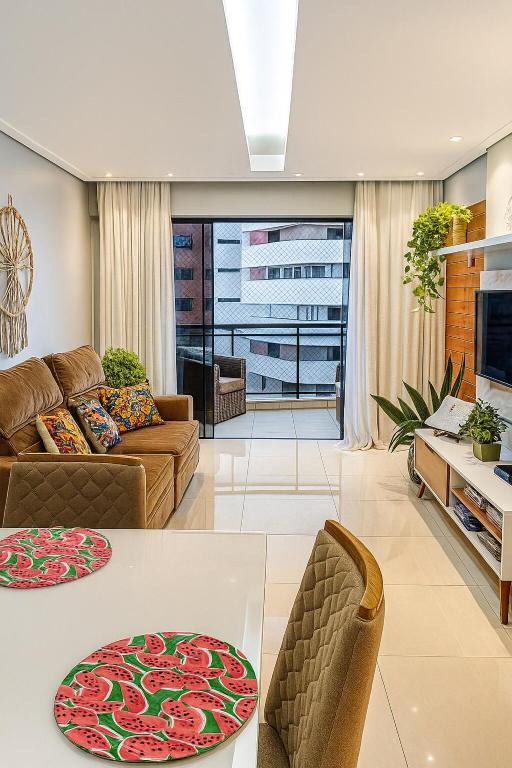 a living room with a couch and a table at Village Prime Umarizal in Belém