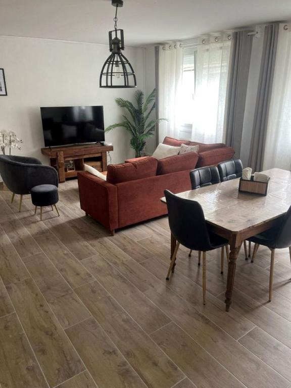 a living room with a couch and a table at Le reflet de la cathédrale in Saint-Omer