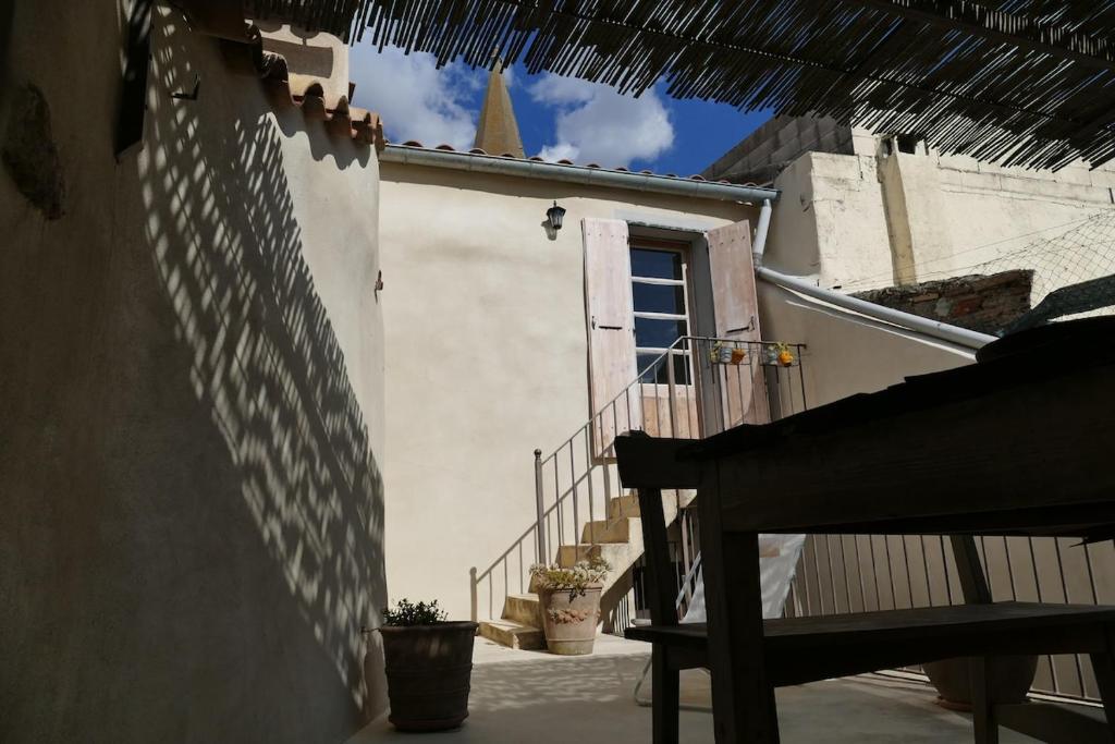 a building with a staircase leading to a door at 17th CENTURY HOUSE with terrace, near to Castle in Capendu