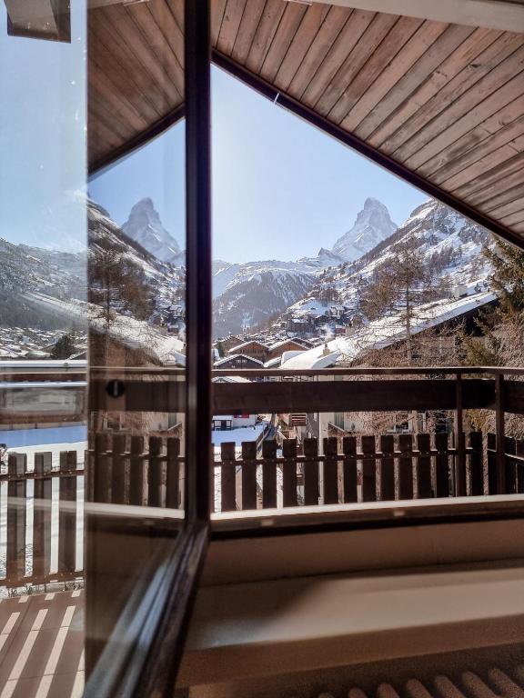 a window view of the mountains from a house at central sky-penthouse with iconic matterhorn view in Zermatt