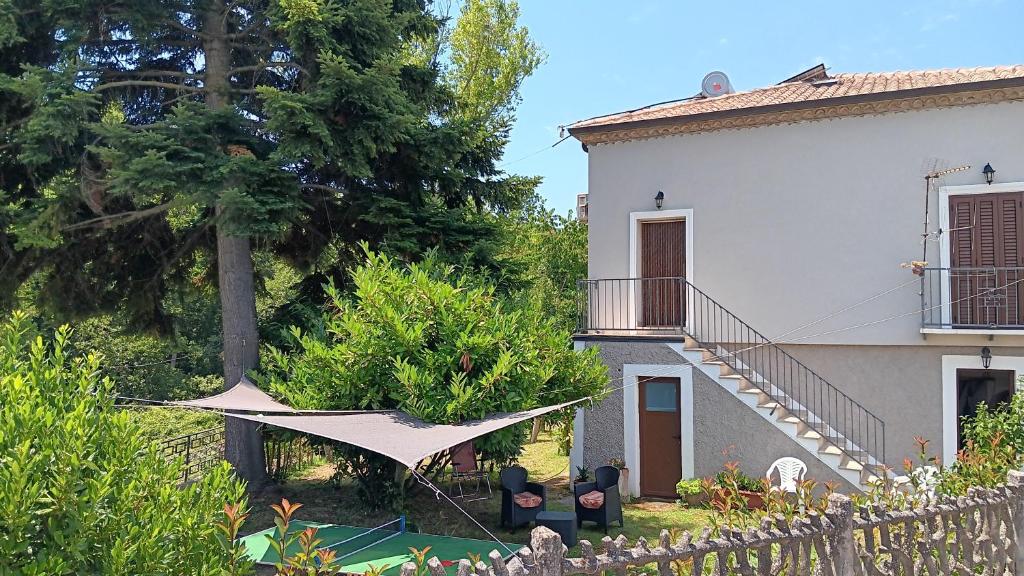 a white house with a fence and a yard at La Casa del Mugnaio in Rotonda