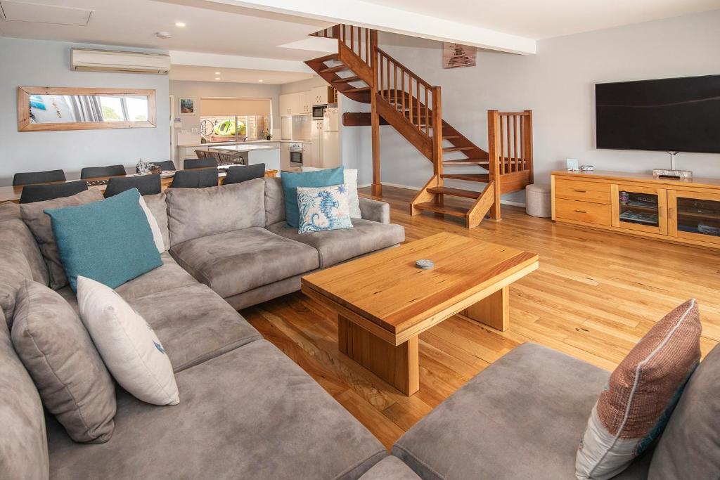 a living room with a couch and a table at Beachside Retreat, WIFI, Kayaks, AC to all rooms in Dunsborough