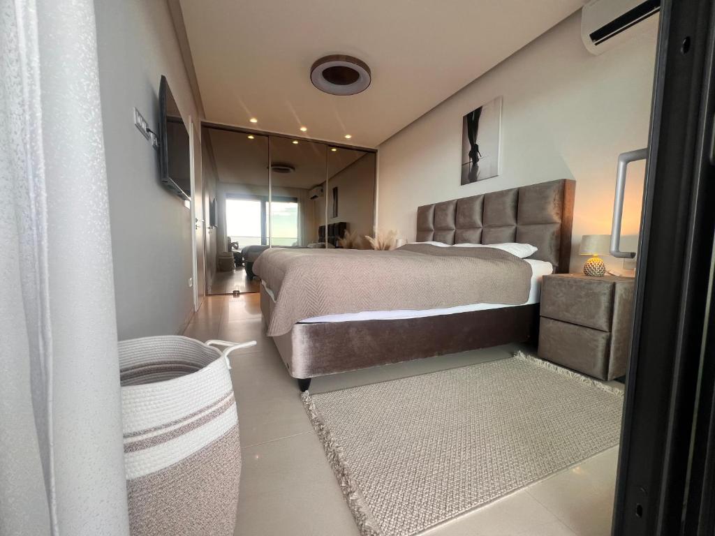 a bedroom with a large bed and a large mirror at Primosten Resort Sunhill Deluxe Apartment Laura in Primošten