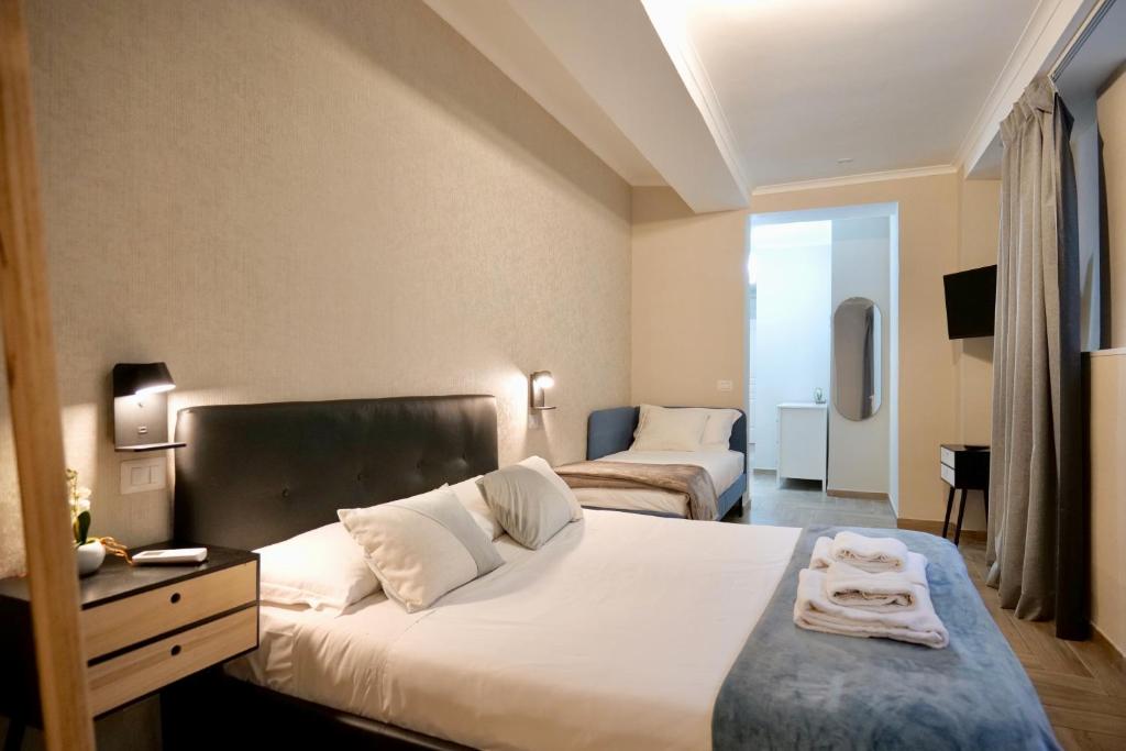 a hotel room with a bed and a bedroom with two beds at Palatino 28 in Rome