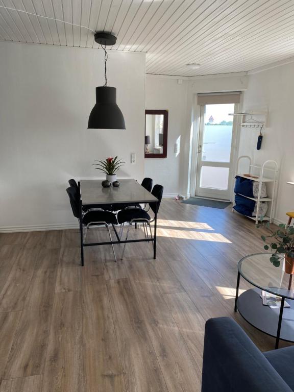 a living room with a table and chairs and a view of the ocean at VV Apartments 50,1 in Ringsted
