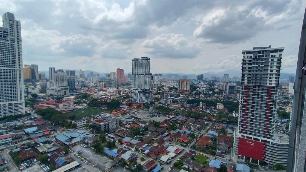 a view of a city with tall buildings at Summer Suites KLCC by CozyNest in Kuala Lumpur