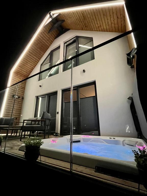 a house with a jacuzzi in front of it at Altitude 2 Matra in Mátraszentimre