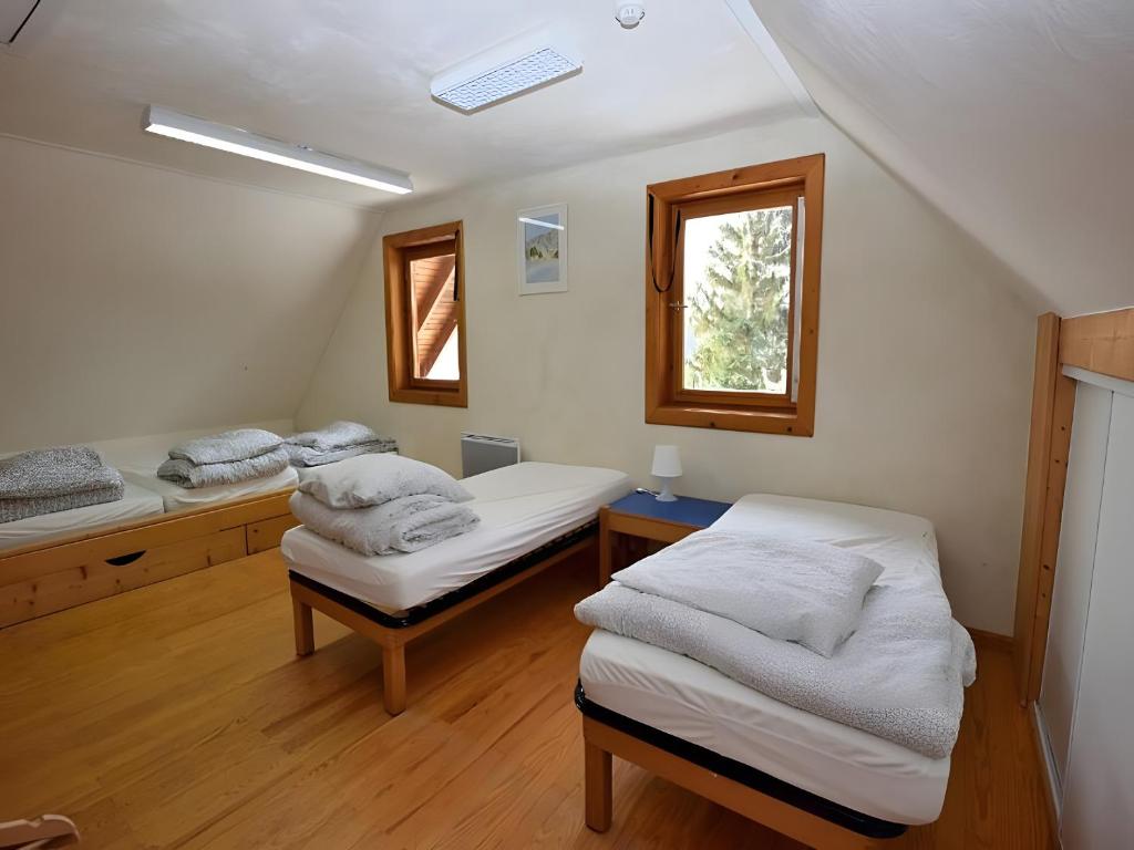 a room with two beds and a window at Chalet De Montagne 14 Couchages in La Morte