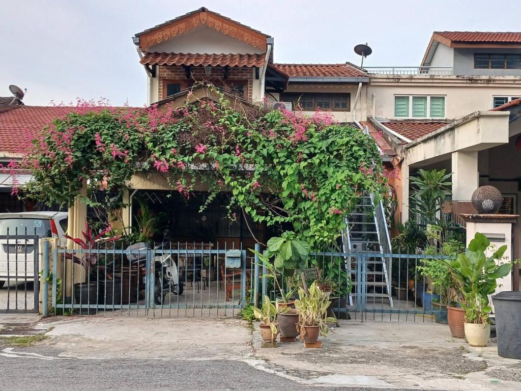 a house with a gate with flowers on it at Serene Mountain Retreat in KL - Entire House for Rent in Kampong Kelang Gates Baharu