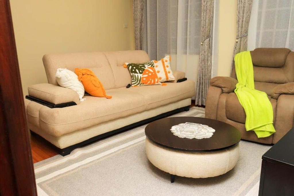 a living room with a couch and a coffee table at Royal Homes in Nairobi