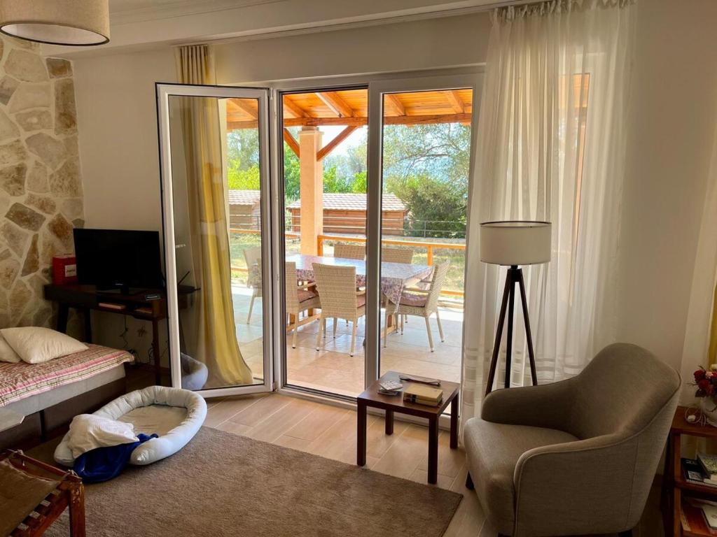 a living room with a chair and a sliding glass door at Villa Bella Vita in Tivat