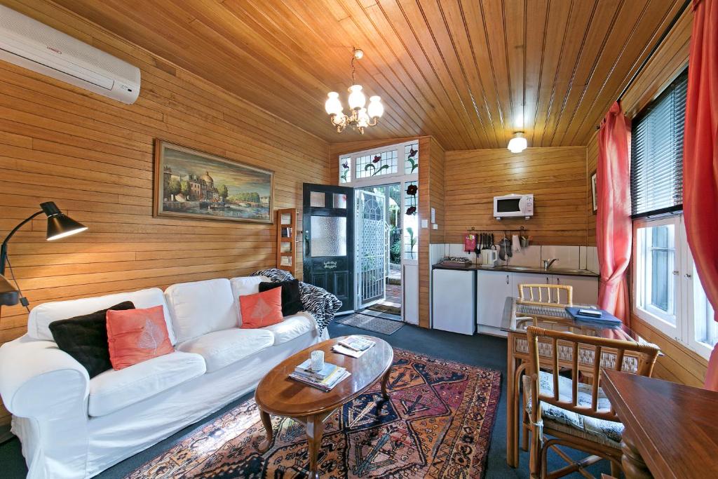 a living room with a white couch and a kitchen at Hillside Country Retreat in York