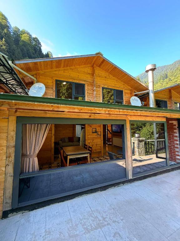 a house with large sliding glass doors on it at Ayder Villa Gencal King in Ayder Yaylasi
