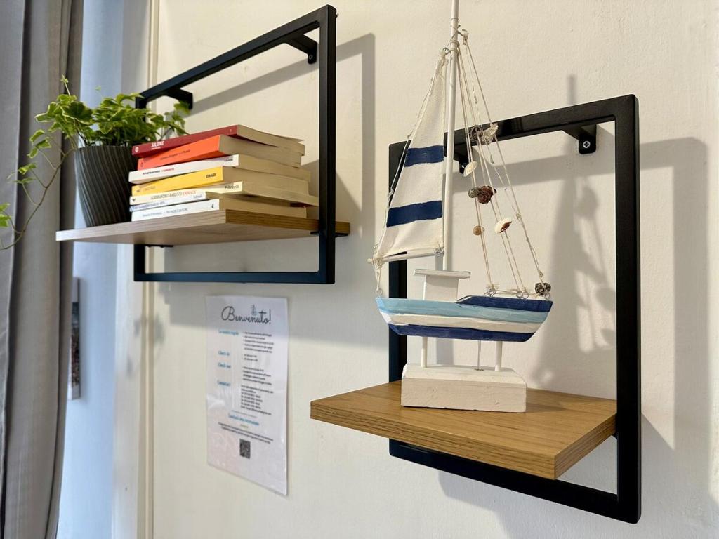 a shelf with a toy boat and books on it at House 130 Francavilla B&B in Francavilla al Mare