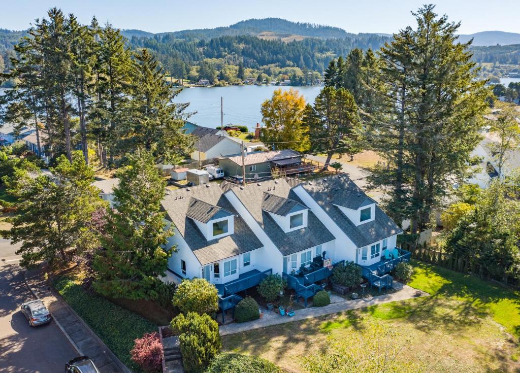 an aerial view of a large white house with trees at Coastal Adventures, Lake, Ocean, Casinos, Hiking in Neotsu