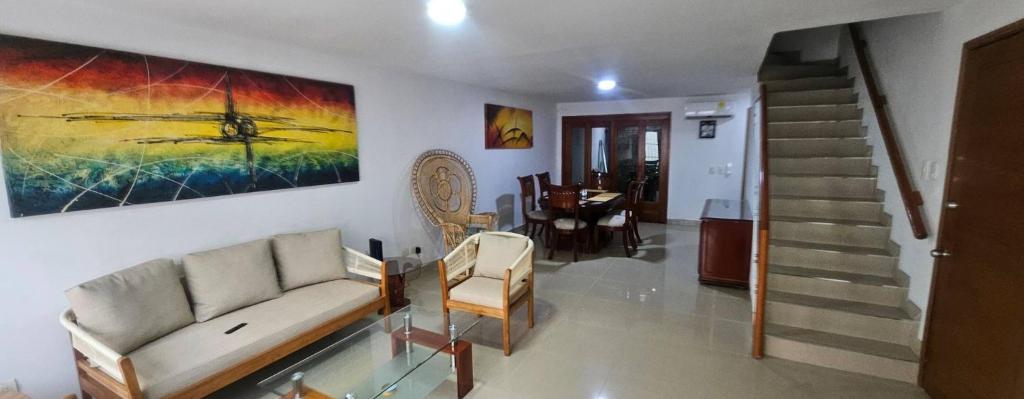 a living room with a couch and a painting on the wall at Guest house with AC close to Historical Centre 2 in Cartagena de Indias