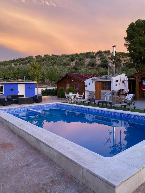 a swimming pool in front of an rv at Casa Tita Mari in Jaén