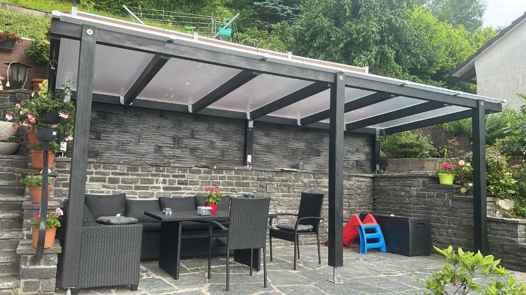 a pergola with a table and chairs under it at Wilhelm in Hornberg